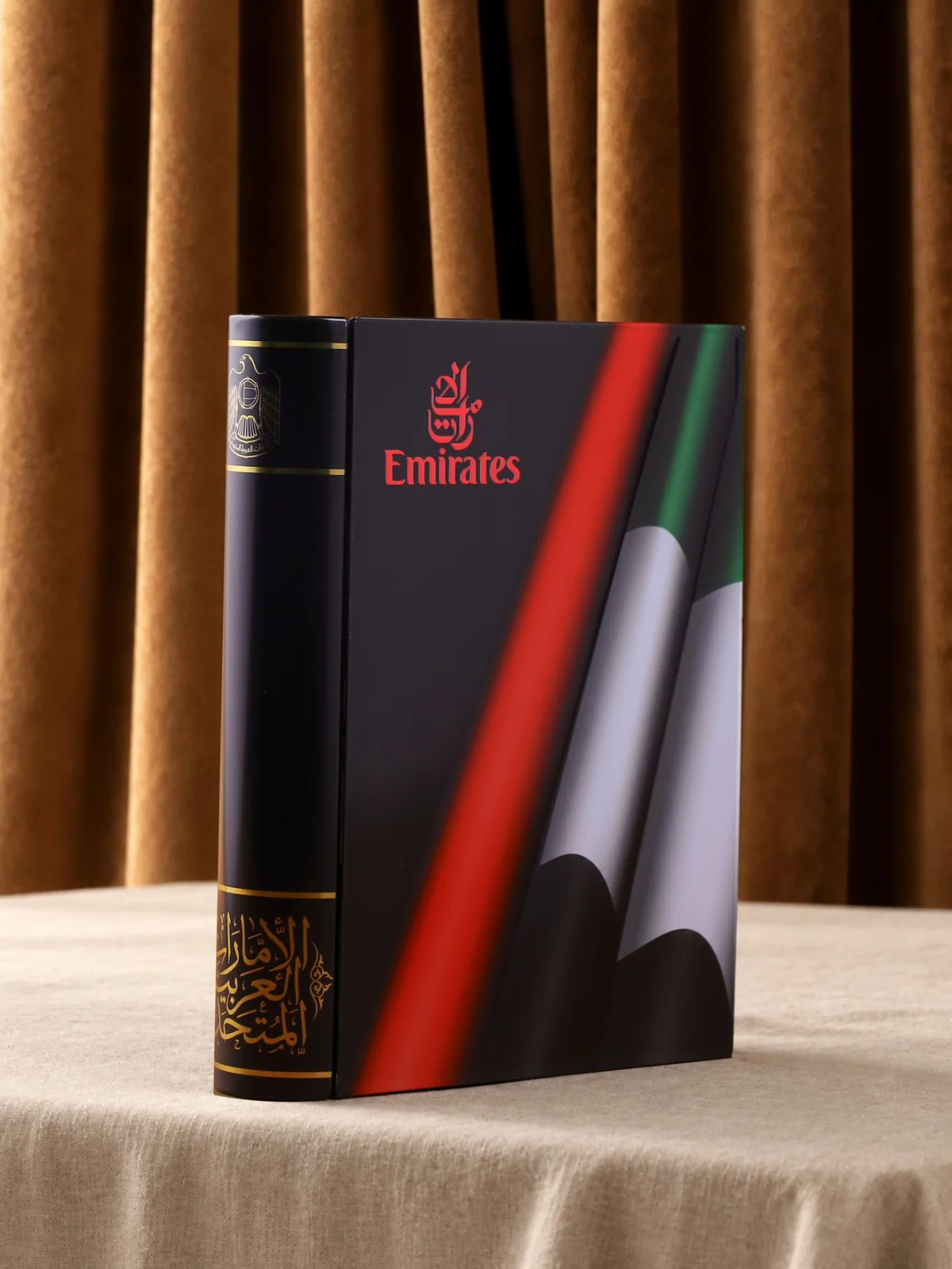 The metal book with a company logo on its cover